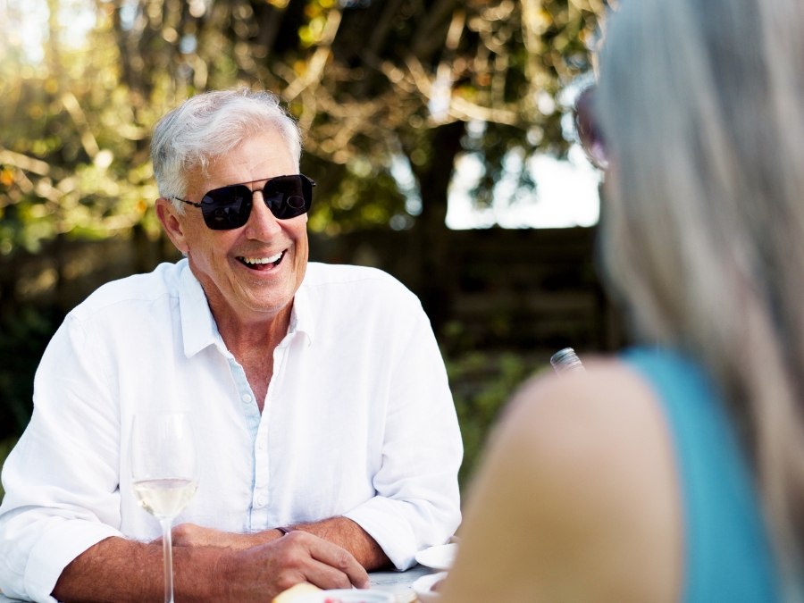A well-dressed man enjoys a pleasant moment at the country club, maybe with his wealth manager, illustrating Gerardi Wealth Management's vision of becoming your trusted partner for financial advice.