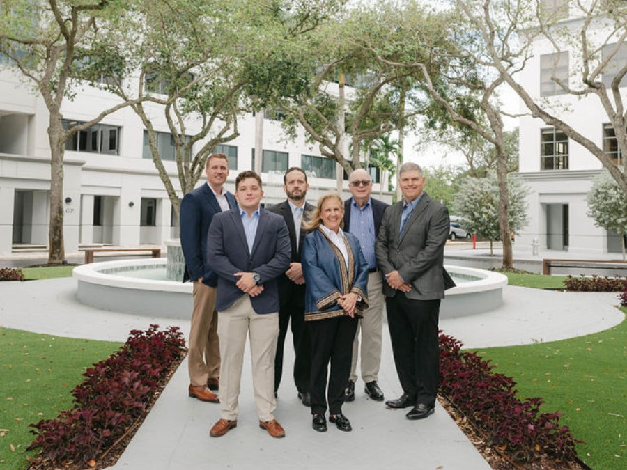 The Gerardi Wealth Management team poses in front of their offices in Boca Raton, Florida